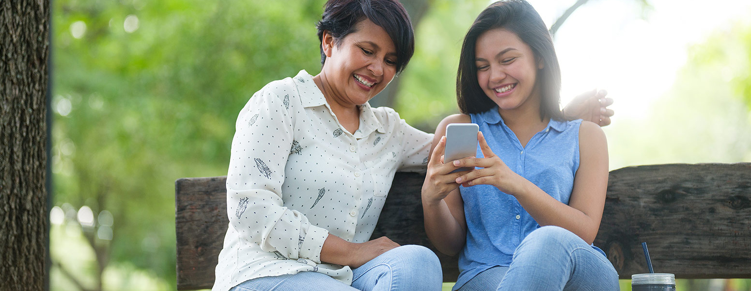 Mom and Daughter looking at a cell phone
